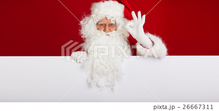 Santa Claus pointing in blank advertisement banner Santa Claus pointing in blank advertisement banner 26667311