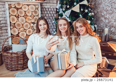 Beautiful girls sitting on the floor near a Beautiful girls sitting on the floor near a 26673141