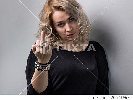Tired blond woman with middle finger Tired blond woman with middle finger 26673968