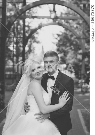 The groom gently hug the bride's shoulders The groom gently hug the bride's shoulders 26675870