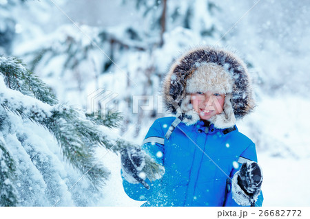 Cute little boy wearing warm clothes playing on 26682772