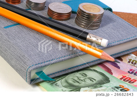 Office tools with Thai banknote on wooden table. Office tools with Thai banknote on wooden table. 26682843