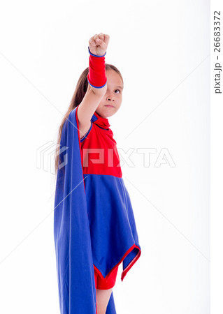 Girl in superhero costume holding arm up Girl in superhero costume holding arm up 26683372