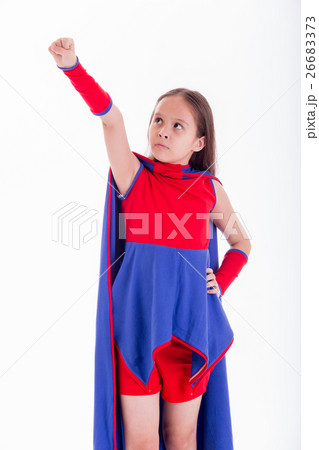 Girl in superhero costume holding arm up Girl in superhero costume holding arm up 26683373