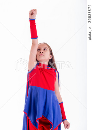 Girl in superhero costume holding arm up Girl in superhero costume holding arm up 26683374