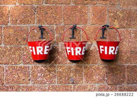 Red fire bin on brick wall background Red fire bin on brick wall background 26688222