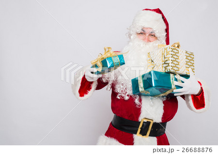 Santa Claus holding pile of gift boxes Closeup Santa Claus holding pile of gift boxes Closeup 26688876