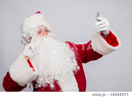 Santa Claus makes a selfie on white background Santa Claus makes a selfie on white background 26688955