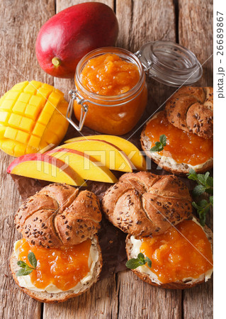 Scones with sweet mango jam and butter close-up Scones with sweet mango jam and butter close-up 26689867