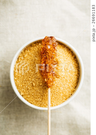 Brown amber sugar crystal on wooden stick. 26691183