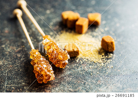 Brown amber sugar crystal on wooden stick. 26691185