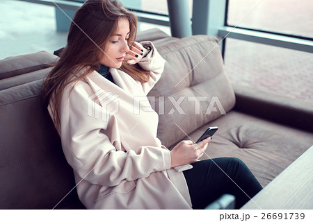 Young girl at the station waiting hall. 26691739
