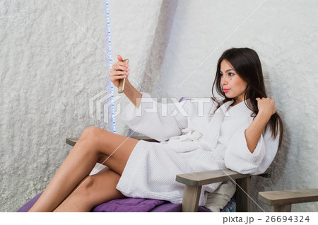 Young woman taking selfie using her smartphone in 26694324