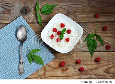 rice porridge with fresh raspberries on a wooden Board 26694670