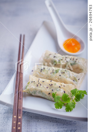 Spring Rolls with Sauce on a wooden surface Spring Rolls with Sauce on a wooden surface 26694763