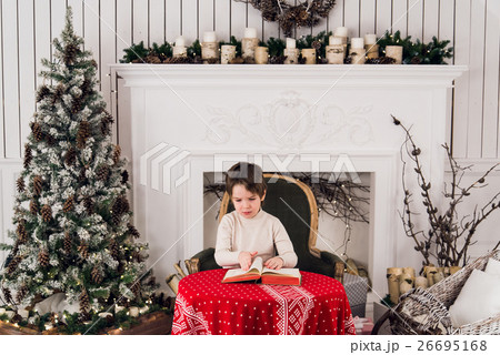 Portrait of cute kid boy sitting on green chair 26695168