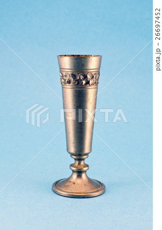 vintage metal goblet cup on blue background vintage metal goblet cup on blue background 26697452