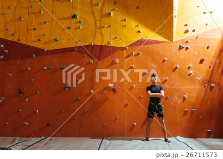 Young man posing near climbing wall 26711573