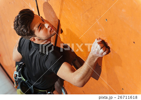 Delighted man spending day in climbing gym 26711618