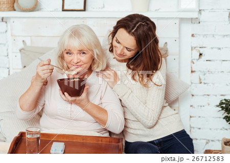 Ceerful elderly woman enjoying her breakfast. 26712583