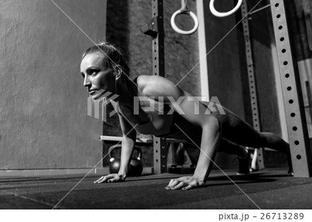 Serious thoughtful woman working out in the gym 26713289