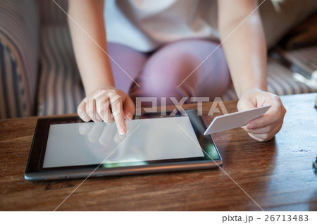 Woman using phone for on line payment 26713483