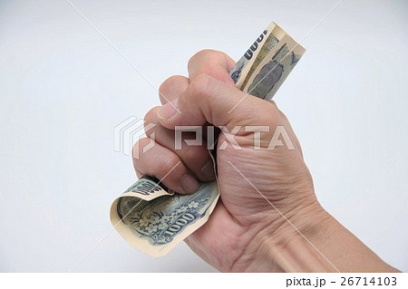お金を握りしめる男性の手の写真素材
