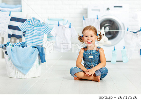 child fun happy little girl to wash clothes and laughs in laund child fun happy little girl to wash clothes and laughs in laund 26717526
