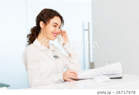 friendly woman behind reception desk administrator 26717978