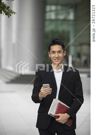 Chinese business man using his mobile phone. 26721325