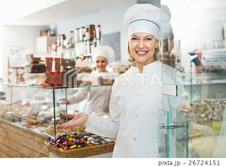 Female staff greeting clients in confectionery 26724151