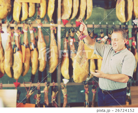 Male client choosing Spanish jamon Male client choosing Spanish jamon 26724152