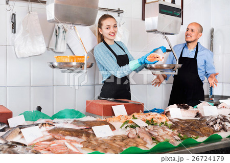 Ordinary fish and seafood store with two sellers indoors 26724179