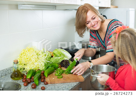 Mother teaching girl to cook. Mother teaching girl to cook. 26724273