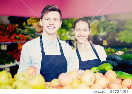 Young girl and a guy laid out apples 26724495