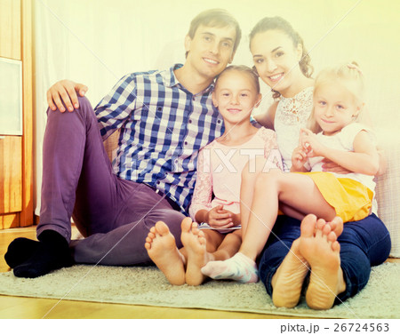 Cheerful parents with two daughters Cheerful parents with two daughters 26724563