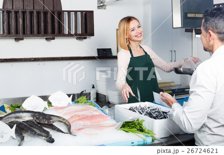 Female seller at fish market . 26724621