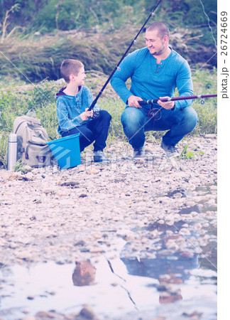 Young father and boy fishing with rods Young father and boy fishing with rods 26724669