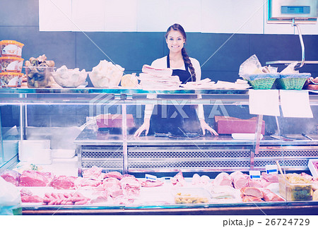 Female butcher with lard and meat in store 26724729