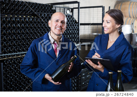 Happy woman with cardboard standing with man 26724840