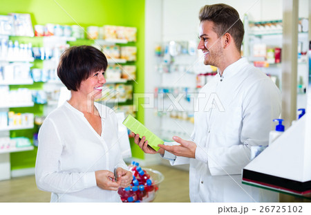 pharmacist helping customers 26725102
