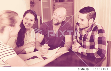 spouses sitting with documents and asking friends for advice 26725103