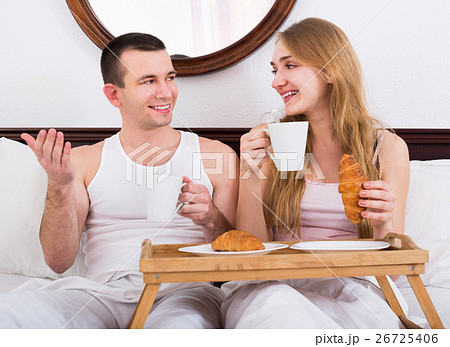 Adult positive couple having healthy breakfast Adult positive couple having healthy breakfast 26725406