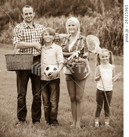 Parents with two children at the lawn. 26725965