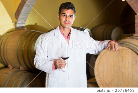 taster of winery with wine in cellar. 26726455