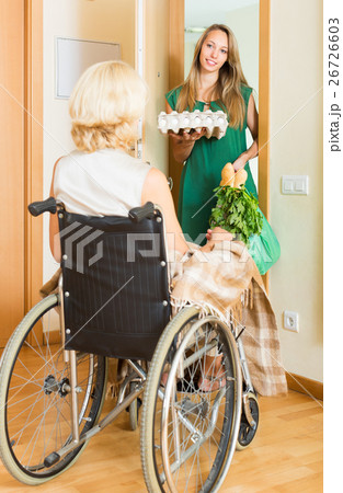 Social worker bringing food to invalid Social worker bringing food to invalid 26726603