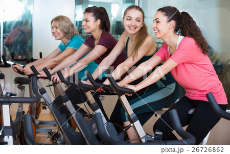 Smiling elderly and young women working out hard 26726862