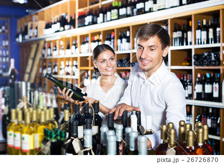 Couple buying bottle of wine Couple buying bottle of wine 26726870