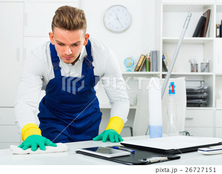 Male professional janitor dusting in office 26727151