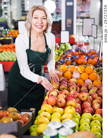 Portrait of positive woman working in grocery 26727356